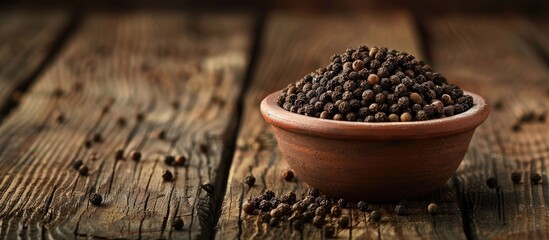 Poster - Clay bowl filled with black pepper on wooden backdrop with ample copy space image conveying notions of healthy eating ayurveda and naturopathy