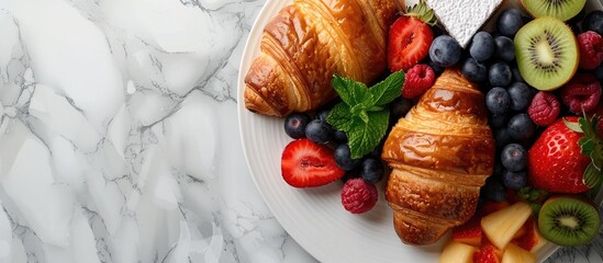 Poster - Top view of a breakfast spread featuring croissants and fresh fruits with copy space image