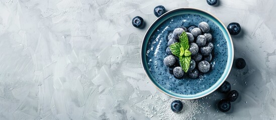 Aufkleber - Blue yogurt smoothie bowl with blueberries and coconut flour on a light concrete surface background providing space for additional image elements