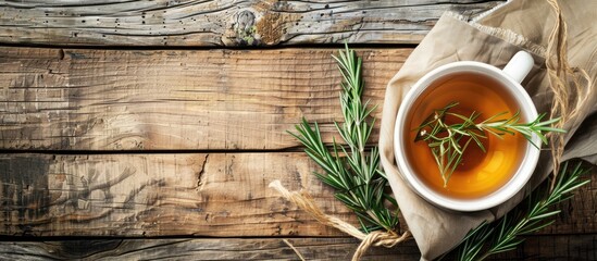 Sticker - A cup of fragrant herbal tea and rosemary on a rustic wooden table with a blank background for text or other content in the photo known as a copy space image