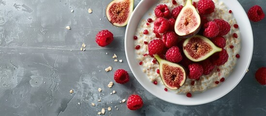 Aufkleber - A bowl with oatmeal porridge topped with fresh raspberries and figs set against a plain background for copy space image