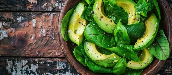 Poster - Avocado salad placed on a rustic table with copy space image featuring fresh green leaves as a meal or snack