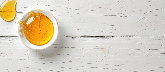 Poster - A dollop of honey showcased on a bright white wooden surface with empty space for custom text or image. Creative banner. Copyspace image
