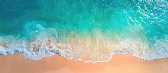 Poster - Aerial view of a sandy beach by the ocean with a transparent blue and turquoise water surface offering a horizontal background with copy space image