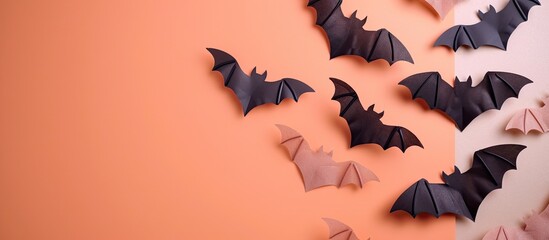 Poster - Colorful Halloween bat ornaments arranged on an orange light pink and beige background with empty space for text. Creative banner. Copyspace image