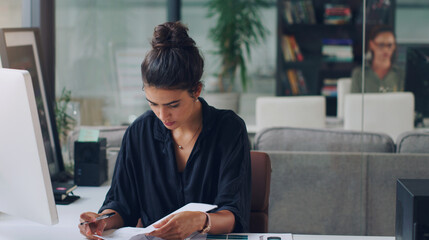 Poster - Creative, business woman and reading paperwork files, list and information in startup office. Documents, planning and publisher with sales report for news, article and research project by computer