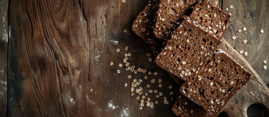 Poster - Chunks of seeded brown bread are sliced on a rustic wooden surface providing a picturesque backdrop for a copy space image