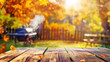 © andreusK - autumn party in backyard garden with grill BBQ, wooden table, blurred background