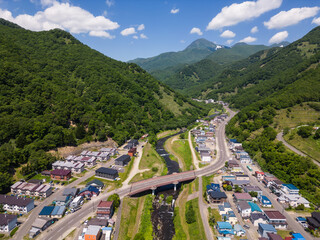 Rausu, Hokkaido: Aerial view of the Rausu town and volcano in the background in the Shiretoko peninsula in Hokkaido in summer in Japan.