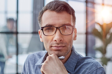 Pensive man in glasses distracted from computer work look in distance thinking or pondering