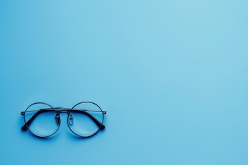 Aufkleber - Round eyeglasses with black frames on a light blue background. Generative AI