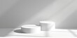 © grigoryepremyan - White background with two cylindrical podiums for product presentation, mockup.