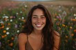 © Milos - A woman with wavy hair and a radiant smile enjoys the serene beauty of a field of flowers, capturing a moment of pure joy and natural bliss in an outdoor setting.