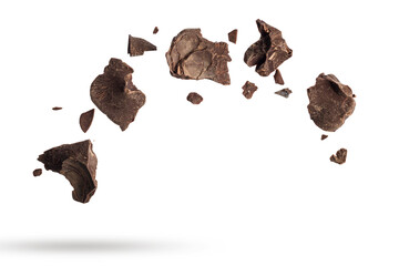 Wall Mural - Dark chocolate flakes falling, isolated on white background.