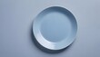© Kromstar Studios - A blank empty blue plate on a blue background with copy space for advertising your products