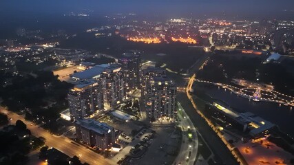 Wall Mural - Ascending aerial footage of the Barrel Yards apartment complex illuminated at dusk, Canada