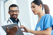 © peopleimages.com - Information, medical or tablet with doctor and nurse in hospital for collaboration, diagnosis or discussion. Healthcare, feedback or smile with happy medicine professional man and woman in clinic