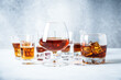 © nadianb - Strong alcohol drink. Cognac, whisky, rum, tequila at light background.