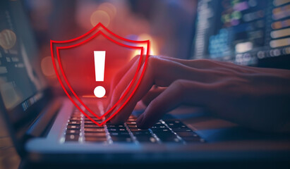 Poster - A person typing on their laptop with an exclamation mark inside of a red shield icon, symbolizing cyber security and online safety