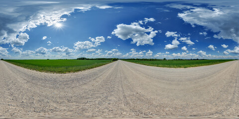 Wall Mural - hdri 360 panorama of blue sky with awesome clouds on roadside of gravel road among fields in equirec