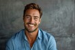 © mattegg - Confident Businessman Smiling in Blue Shirt Against Gray Background