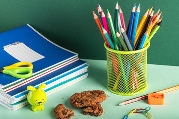 Wall Mural - School stationery on a green background. Organization of a schoolchild's workplace.