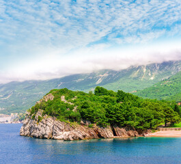 awesome landscape of sea gulf with beautiful turquoise water with amazing green forest shore wwith pakr and hotel and nice green mountains on background