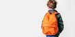 © XC Stock - young boy wearing a backpack is seen from behind on a white background with copy space for text. back to school concept.