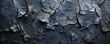 © Volodymyr - A dark, cracked stone texture background with rugged details and deep shadows, offering a bold and intense look.