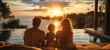 © QuietWord - father mother and son sitting together at pool side with sunset over seascape