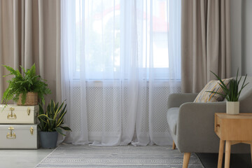 Sticker - Comfortable sofa and elegant curtains in living room. Interior design