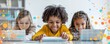 © Georgii - Diverse children enjoying digital learning on laptops and tablets