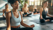 © vrozhko - Group of woman practicing yoga meditation class in studio