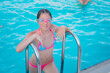 © Климов Максим - A teenage girl in swimming goggles comes out of the pool. Portrait of a young girl swimmer.
