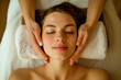 © LidiaLens - Young woman experiencing a soothing facial massage in a peaceful spa setting