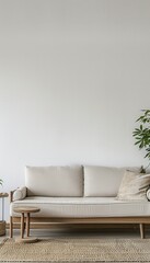 Aufkleber - A white sofa with wooden frame and cushions sits in front of a white wall, with a wooden side table and a woven rug in front of it. A leafy plant is in the background. Generative AI