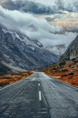 Aufkleber - A scenic view of a mountainous landscape with a winding road and distant peaks
