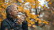 © Maestro - Senior man drinking water outdoors in autumn forest