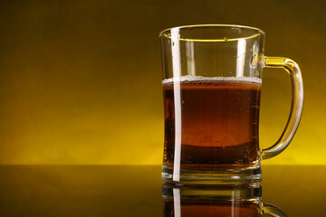 Wall Mural - Glass of beer with froth on dark table, closeup