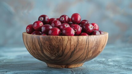 Wall Mural - Fresh ripe cranberries in a rustic wooden bowl on a textured surface