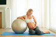 © TamJam/peopleimages.com - Relax, happy and pregnant woman with fitness ball in home for healthy weight gain, circulation and balance. Girl, belly and yoga in house for pelvic floor strength, flexibility and reduce back pain.