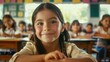 © vefimov - A young girl is smiling at the camera in a classroom. The other children in the room are looking at her