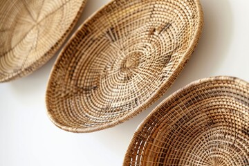 Poster - Three wicker baskets suspended from a wall, filled with unknown contents