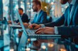 © 为轩 张 - Close-Up of Business Professionals in Suits Working at Modern Office Desks, Typing on Laptops and Engaging in Collaborative Tasks. Elegant Workspace and Employee Productivity Concepts.