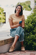 © HockleyM2/peopleimages.com - Smile, smartphone and face of business woman with positivity, happy and confident attitude. Entrepreneur, pride and texting professional, creative designer or freelancer in outdoor garden park
