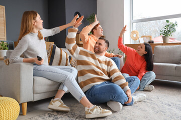 Sticker - Group of happy young friends giving each other high-five at home