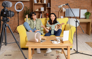 Wall Mural - Happy young women recording podcast at home