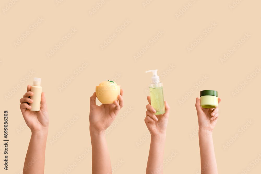 Female hands with different cosmetic products on beige background
