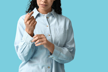 Poster - Young African-American woman in stylish collar shirt on blue background