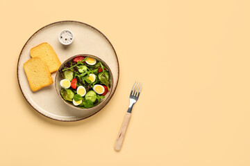 Wall Mural - Bowl of tasty salad with boiled quail eggs, sea salt and toasts on color background